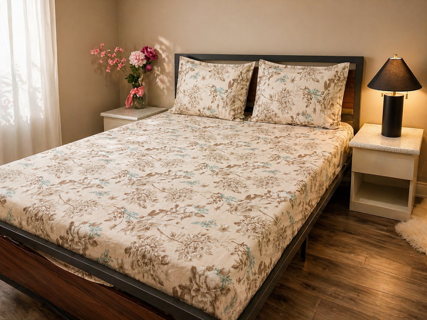 Bedroom with floral bedspread, nightstands, and a lamp.
