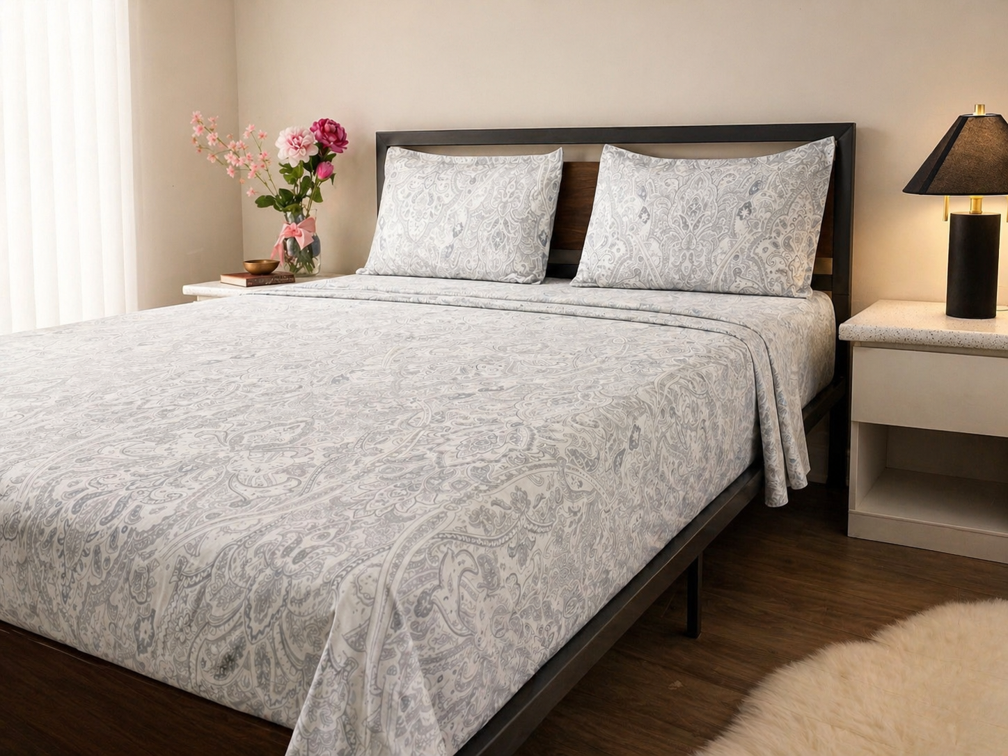 Cotton bedsheet in  Bedroom with a queen bed covered in a gray paisley comforter and matching pillows.