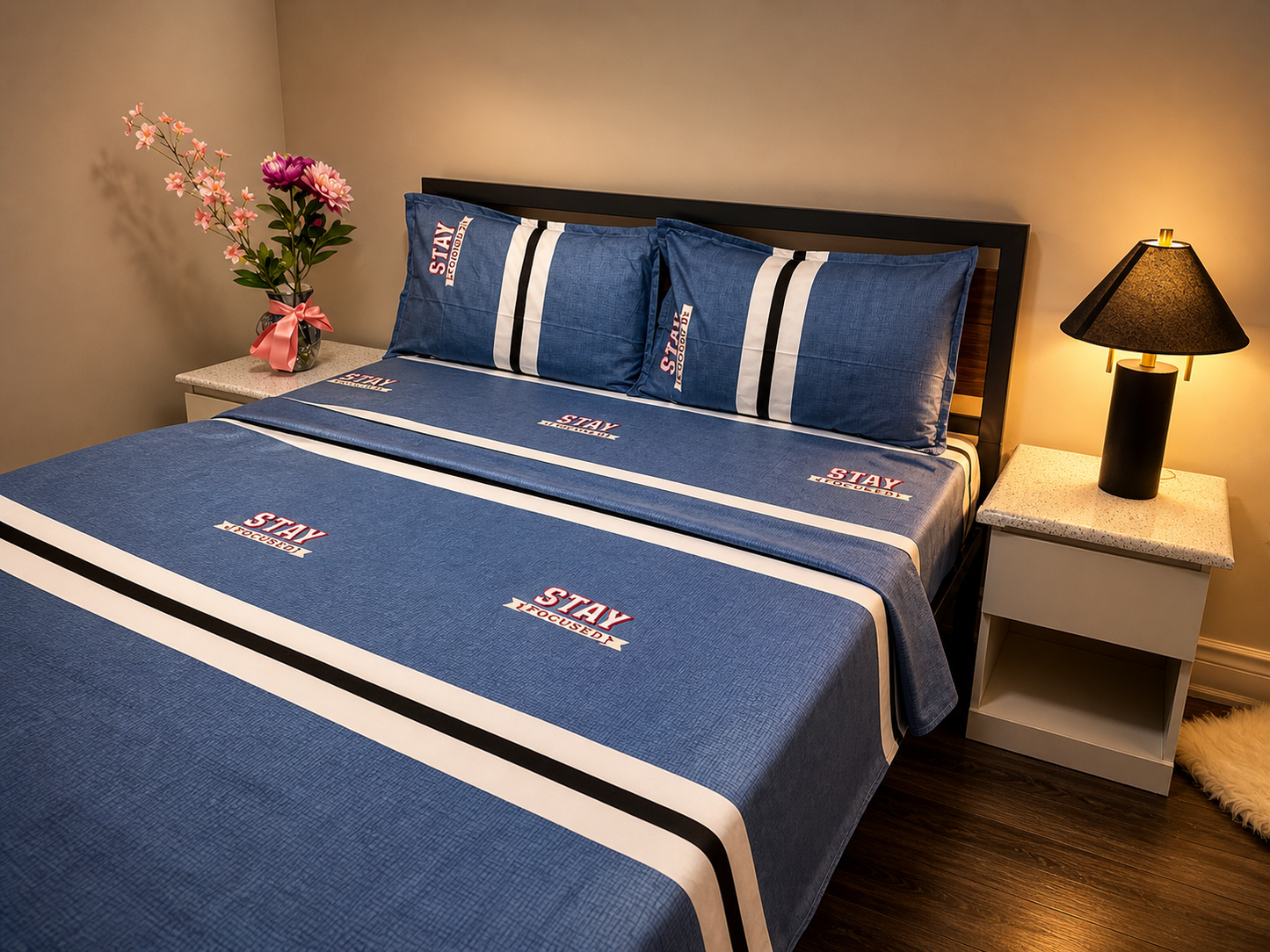 Blue bedding set with white and black stripes on a bed in a bedroom setting.