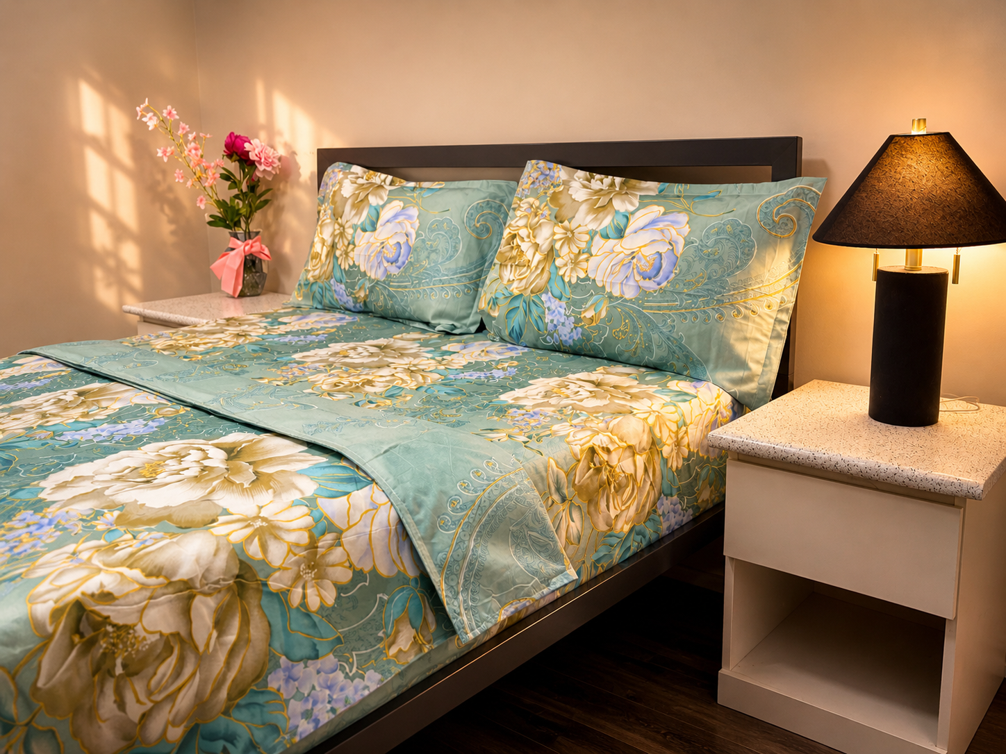 Floral bedspread on a bed with matching pillows in a bedroom setting.
