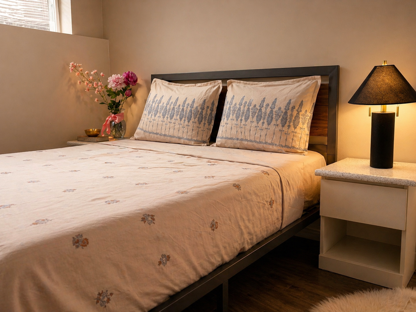 Bedroom with a bed, nightstand, and lamp.