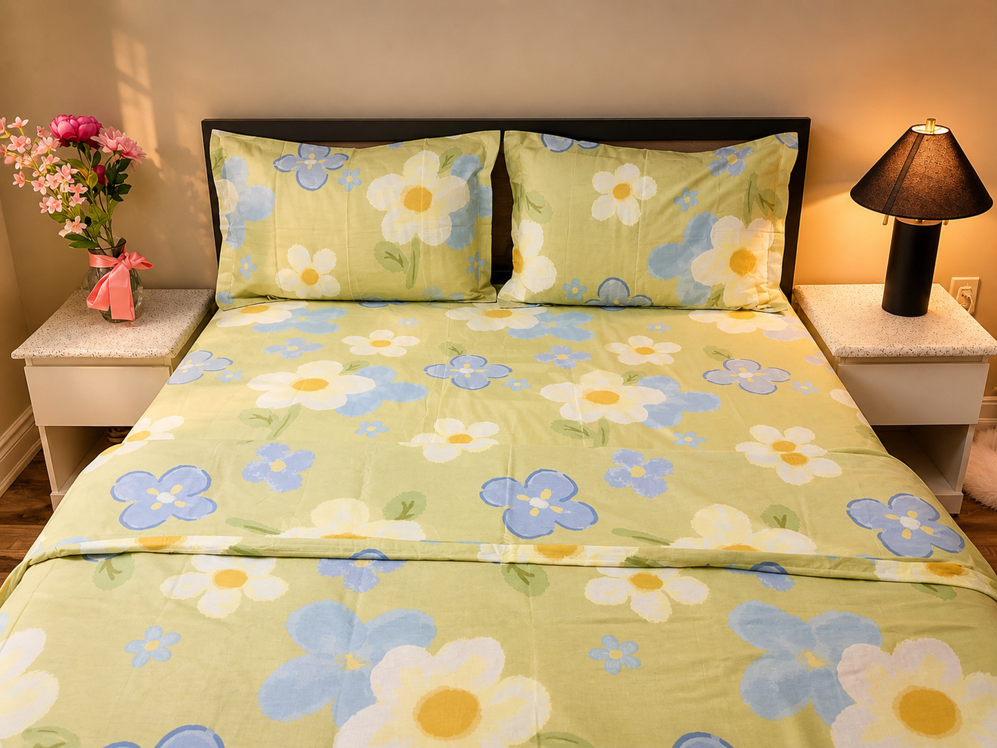 Floral bedspread with matching pillows on a bed in a bedroom setting.