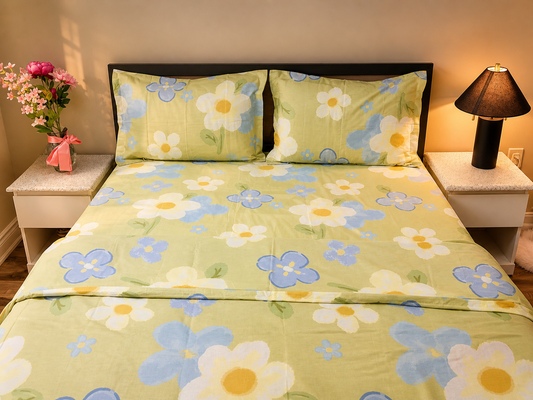 Floral bedspread with matching pillows on a bed in a bedroom setting.