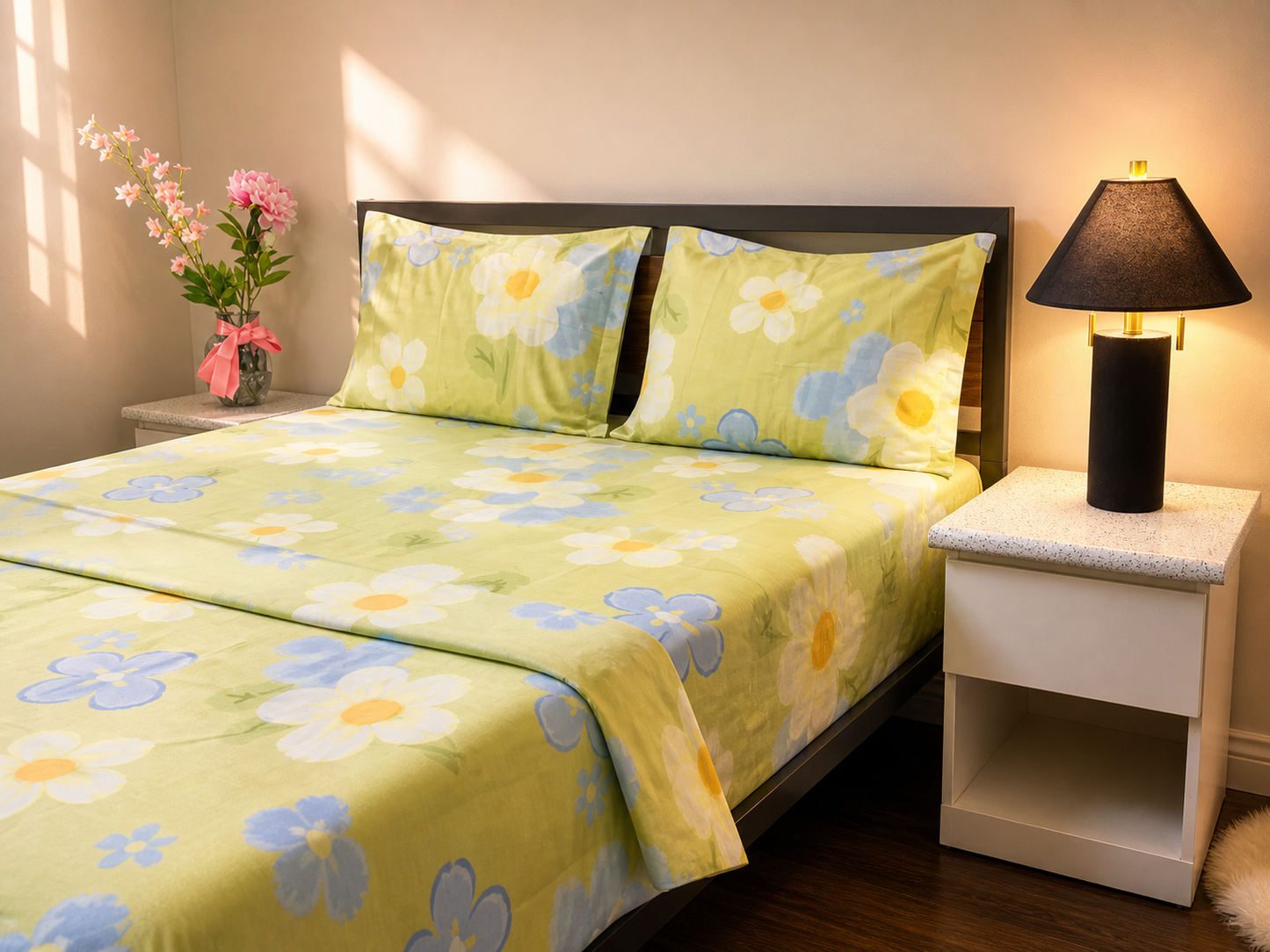Floral bedspread with matching pillows on a bed in a bedroom setting.